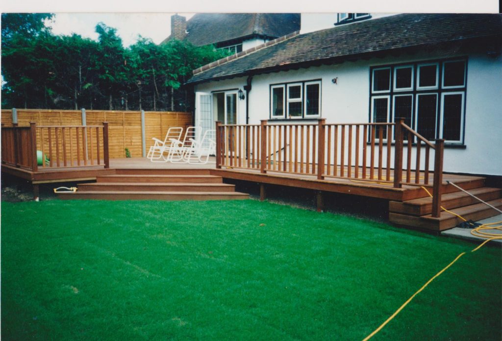 Hardwood raised deck with handrails to back of property in Surrey