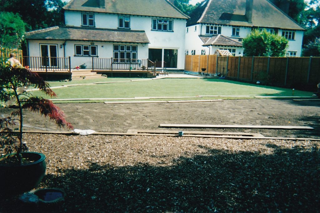Laying turf for large garden lawn with decking