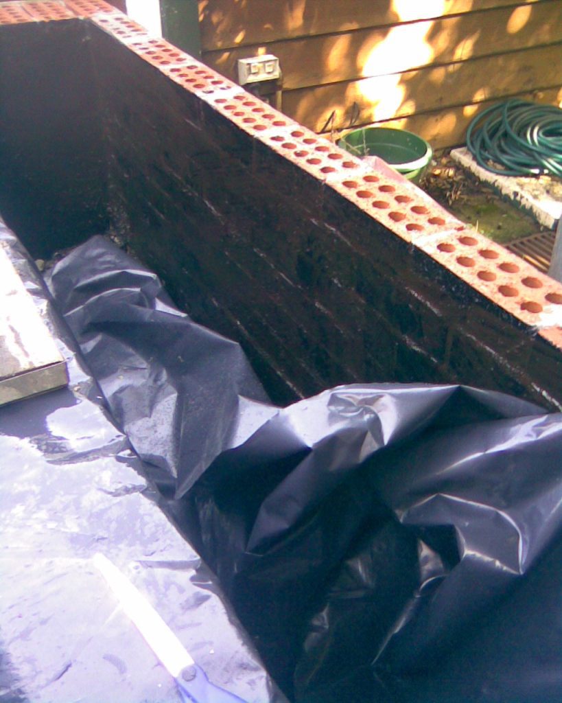 Lining brick planters with plastic membrane