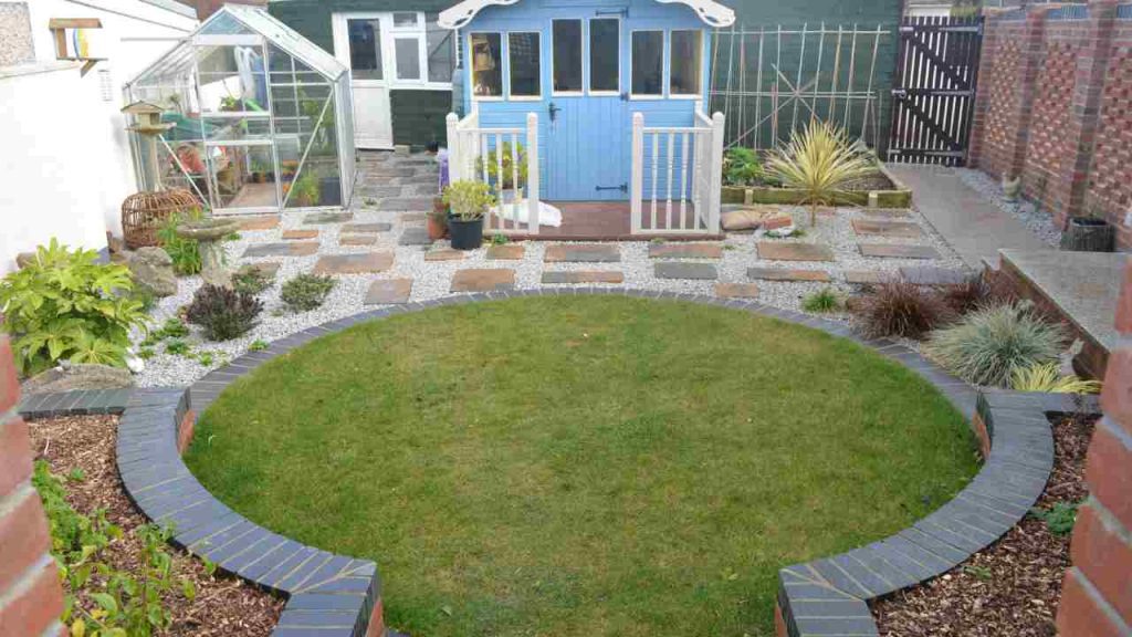 garden makeover- lawn circle with engineering brick edge, shed and decking