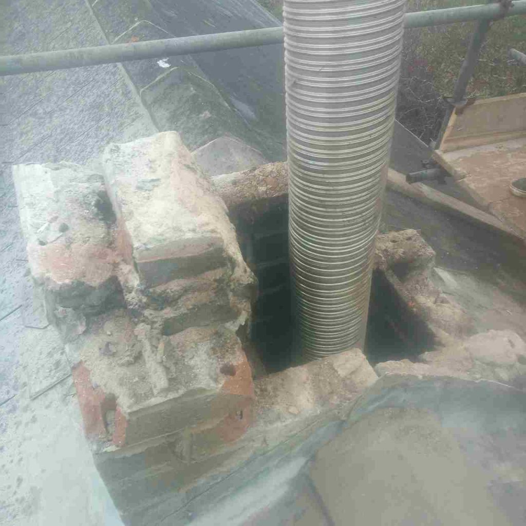 dismantling old stack exposing flue liner