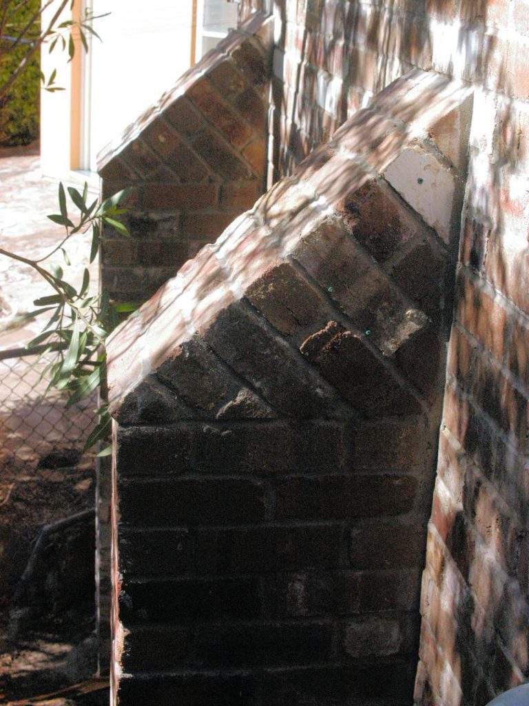 Brick buttresses and retaining wall with brick tumbling in