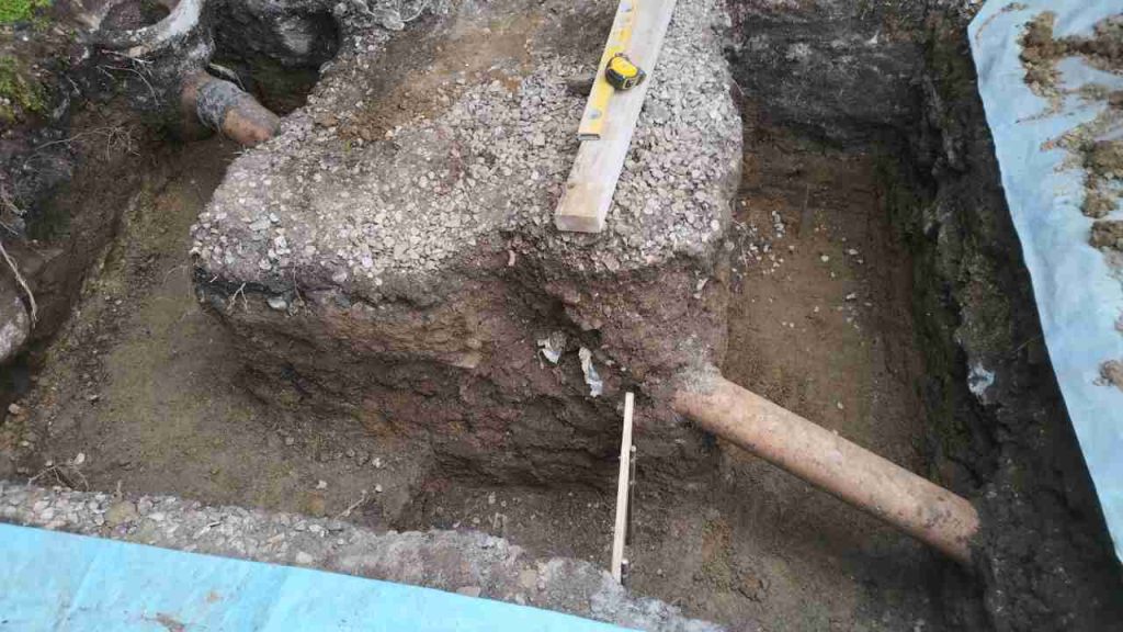 Footings for porch stepped under soak-a-way pipe
